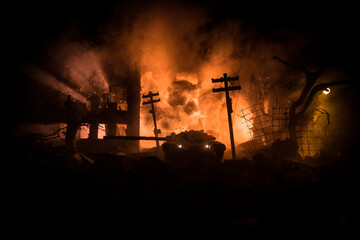 Fototapeta premium War Concept. Military silhouettes fighting scene on war fog sky background, World War Soldiers Silhouette Below Cloudy Skyline At night. Battle in ruined city.