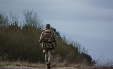 British army soldier completing an 8 mile tabbing exercise with fully loaded 25Kg bergen