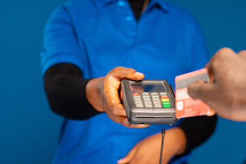 person swiping their credit card on a mobile point of sale device