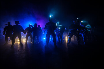 Anti-riot police give signal to be ready. Government power concept. Police in action. Smoke on a...