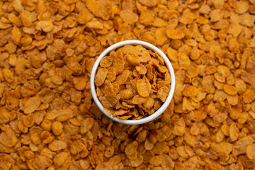 oranges corn cereal in a white bowl with cereal on the side for a healthy and healthy diet