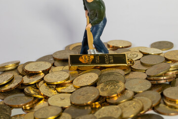 Industrial Engineering worker digging with gold bar and coin as business and industry concept....