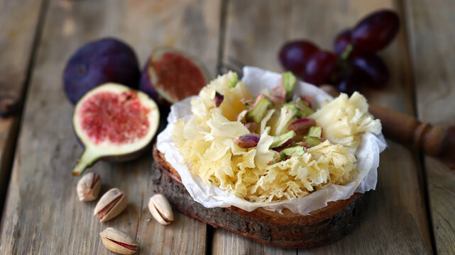Cheese tet de moine with figs and pistachios.