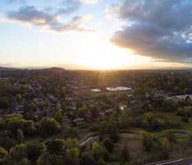 Small city. Lots of greenery - trees, lawns. Pedestrian paths and highways. Small houses. Beautiful landscape. View from above. Aerial photography. Tourism, advertising of tourist destinations.