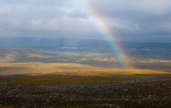A rainbow in the direction of Syterstugan observed while hiking the trail between Syter and the glacier. A part of Kungsleden hiking trail between Hemavan and Ammarnas, Lapland, Sweden © Alena V
