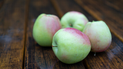 Autumn apples in the rain. Organic apples on the wooden table