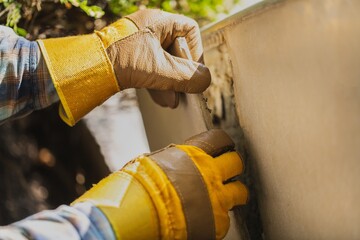 A worker with gloves lays down and dismantles the ceramic tiles of the stairs © BillionPhotos.com