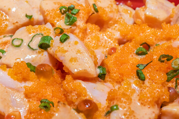Close-up, Salmon fillet burn rice with salad spicy dressing, shrimp roe and caviar with vegetables.