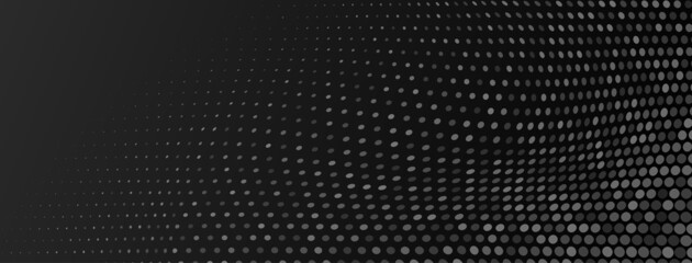 Abstract halftone background made of small round dots of different sizes in black and gray colors
