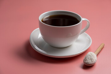Coffee and collagen powder on pink background