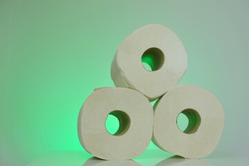 Toilet paper rolls .Organic bio toilet paper rolls set on light green background.Hygiene and cleanliness concept. High quality photo