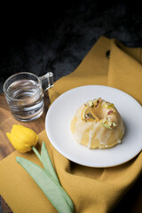Lemon pound cake served for dessert on white plate in dark background. This cake made from lemon juice, butter, and other ingredients. The taste of the cake is sweet and sour.