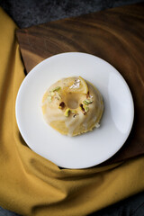 Lemon pound cake served for dessert on white plate in dark background. This cake made from lemon juice, butter, and other ingredients. The taste of the cake is sweet and sour.