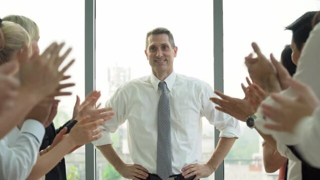 great success of the leader. leadership and group of business people applauding or clapping hand celebrating to success of  organization business in Meeting room on window in office . boss and worker