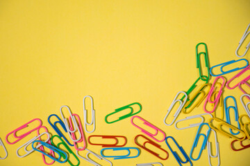 paper clips on a yellow paper. whitespace paperclip background for your text