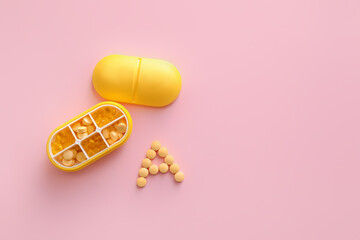 Letter A made of pills and organizer on color background