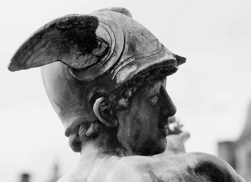 Helmet with wings of antique god of commerce, merchants and travelers Hermes (Mercury). Ancient statue. Black and wwhite image.