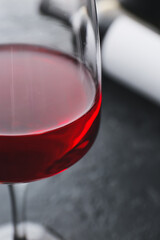 Glass of red wine on dark background, closeup