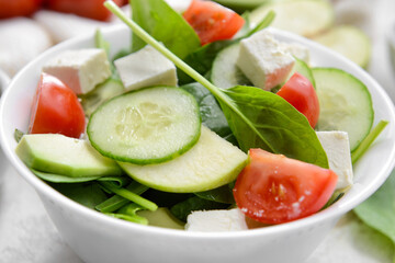Plate with healthy fresh salad on light background, closeup
