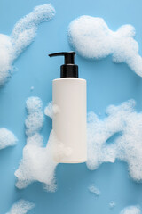 Bottle of cosmetic product with foam on color background - obrazy, fototapety, plakaty