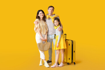 Happy family with luggage on color background. Concept of tourism