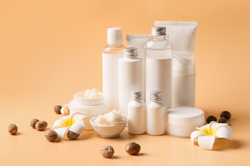 Fototapeta na wymiar Bowl of shea butter, nuts and cosmetic products on color background