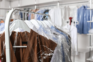 Rack with clothes at modern dry-cleaner's
