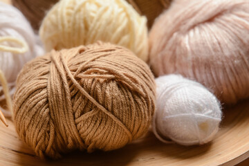Fototapeta na wymiar Wooden board with knitting yarn, closeup