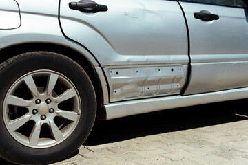 Damaged car, a damaged car waiting for a tow truck by the roadside.