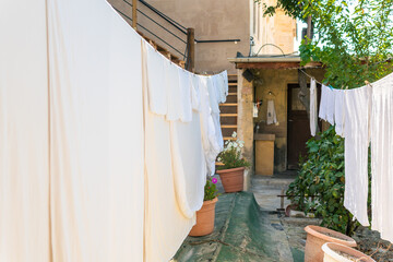 Hanging laundry, white laundry waiting to dry in a sunny weather.