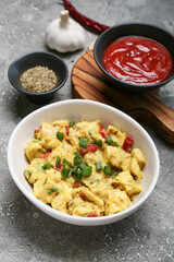 Bowl of tasty chicken curry on grunge background