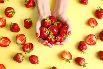 Woman with beautiful manicure and strawberry on color background