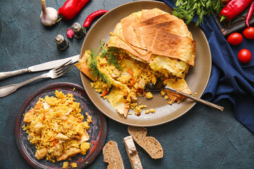 Plates with tasty Shah Pilaf on dark background