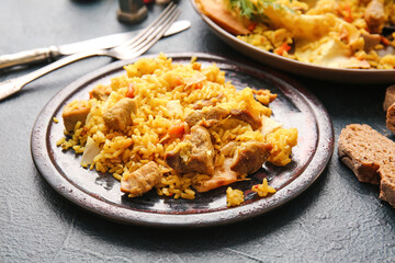 Plate with tasty Shah Pilaf on dark background