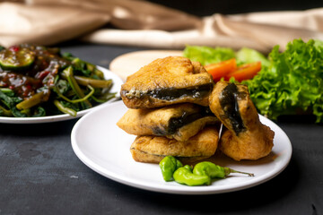 Kangkung Petis and Tahu Petis Susur, Indonesian Tradional Food from Semarang City on white plate and black background
