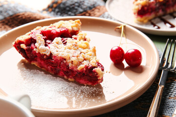 Plate with piece of tasty cherry pie on table, closeup