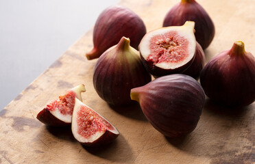 Lots of figs on the cutting board and cut figs.