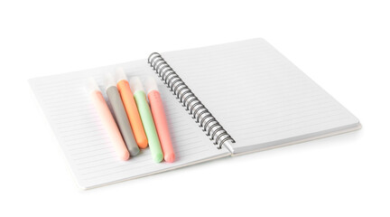 Opened notebook and felt tip pens on white background