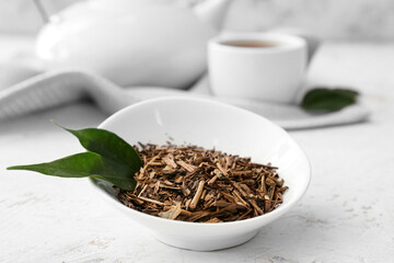 Bowl of dry hojicha green tea on table