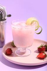 Glass of strawberry Pina Colada cocktail and berries on color background