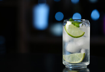 Glass of cold gin tonic on table in bar
