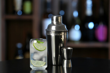 Glass of cold gin tonic on table in bar