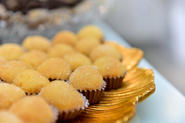 Sugary party sweet on a golden tray, condensed milk candy balls, candy balls