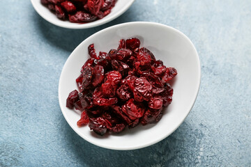 Plate with tasty dried cranberries on color background, closeup