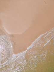 Fototapeta premium Aerial view of sandy beach and ocean with waves