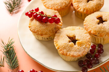 Plate with tasty mince pies on color background, closeup
