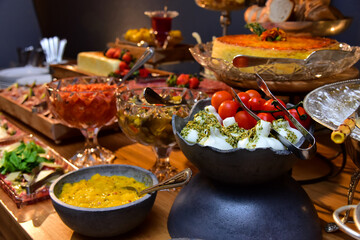 burrata with cherry tomatoes and pesto sauce, buffet table setting, party table setting, table setting