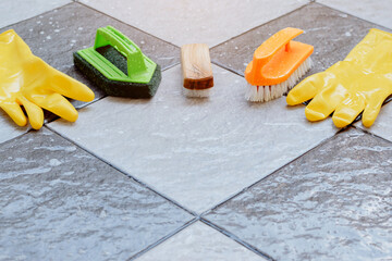 Group of cleaning equipments placed on a wet tiled floor.