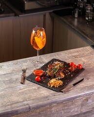 Wineglass and steak with vegetables in restaurant