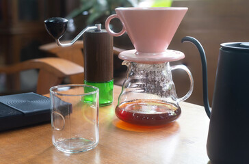 Pour over Coffee Dripper  water kettle coffee grinder and glass on the wooden table